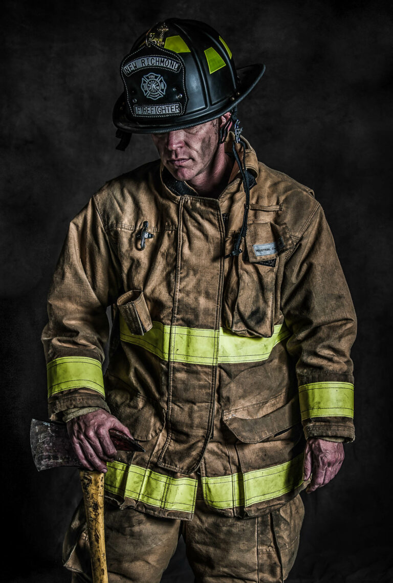 Dramatic portrait of a dirty firefighter looking down