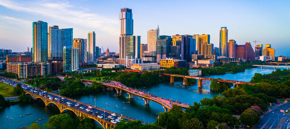 Aerial photo of the downtown skyline or cityscape of Austin, Texas with the bridges over the river in the foreground