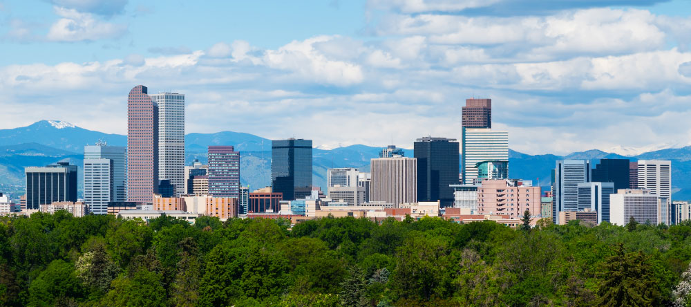 Skyline or cityscape of Denver, Colorado showing the Rocky Mountains in the background
