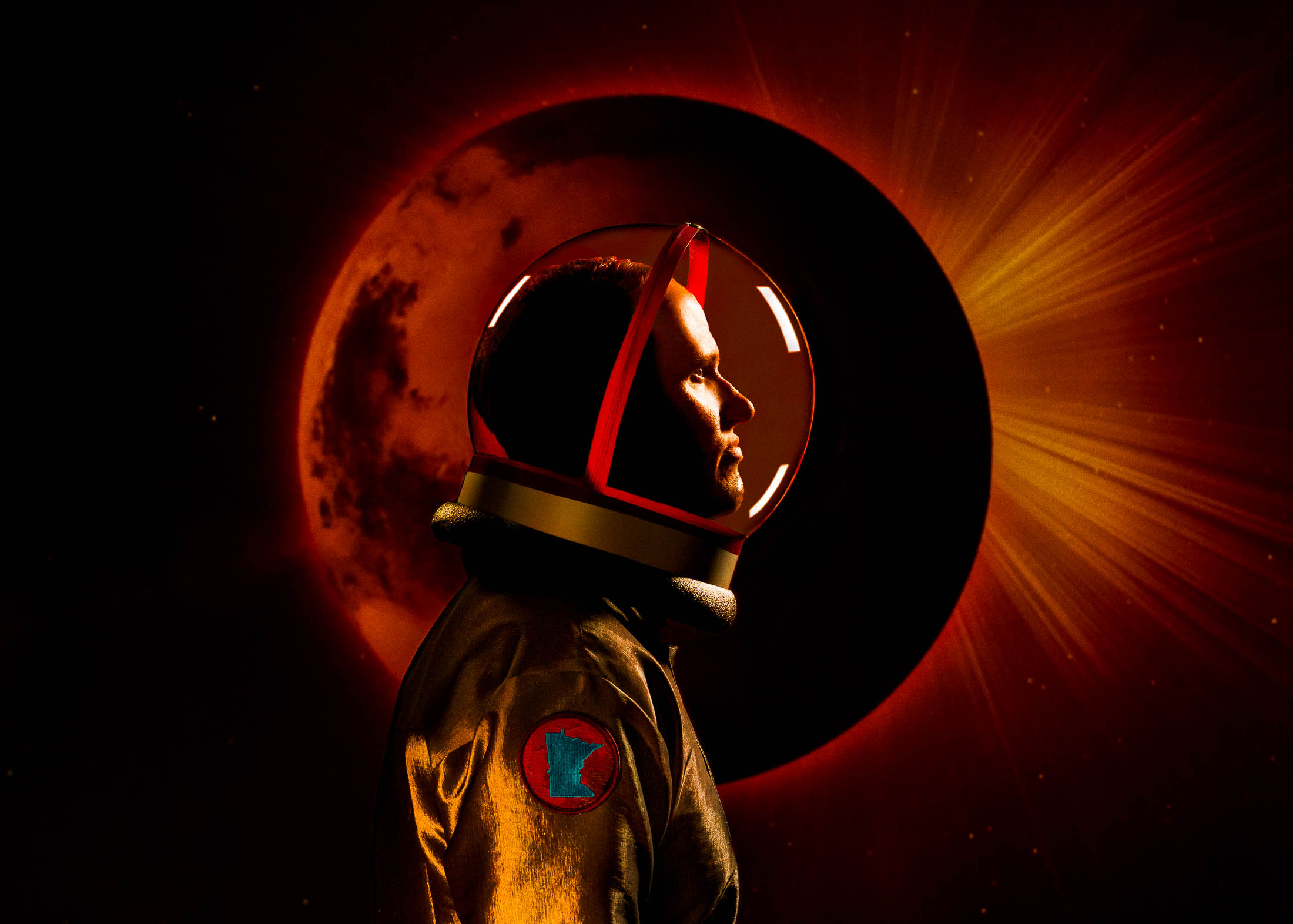 Conceptual portrait of a man wearing a space suit looking from Mars