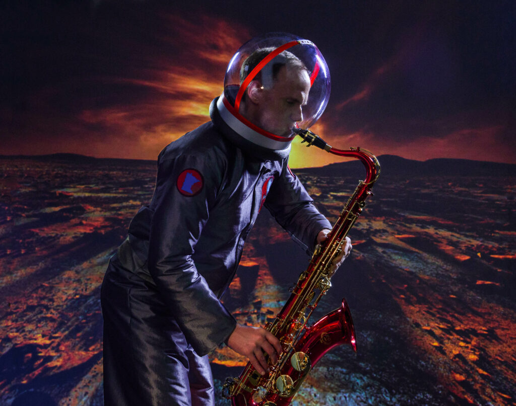 Man wearing a space suit playing a saxophone